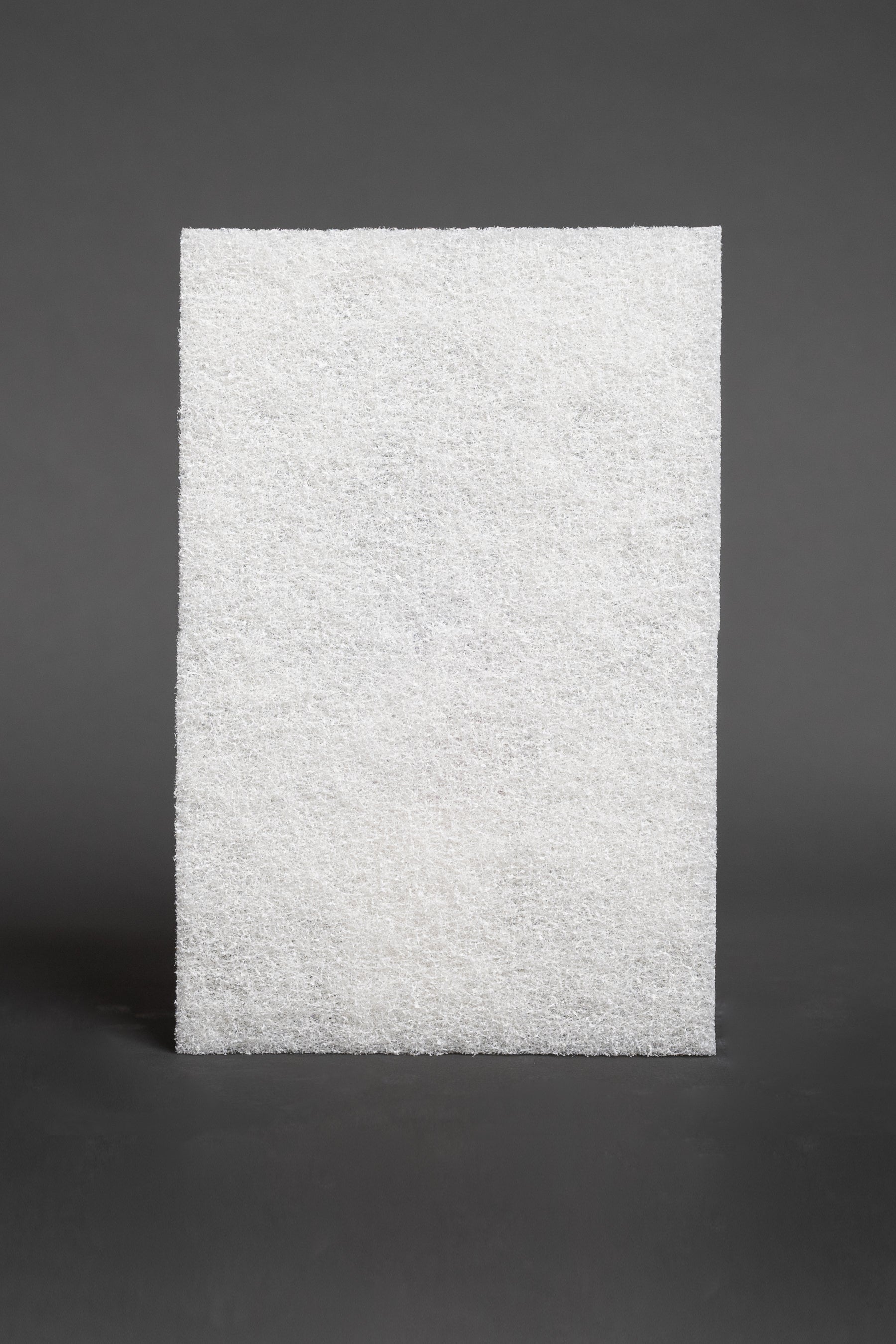 Nonabrasive scrubbing pad tor glass